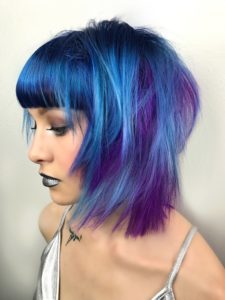 Woman with bright blue & purple Acid Hair