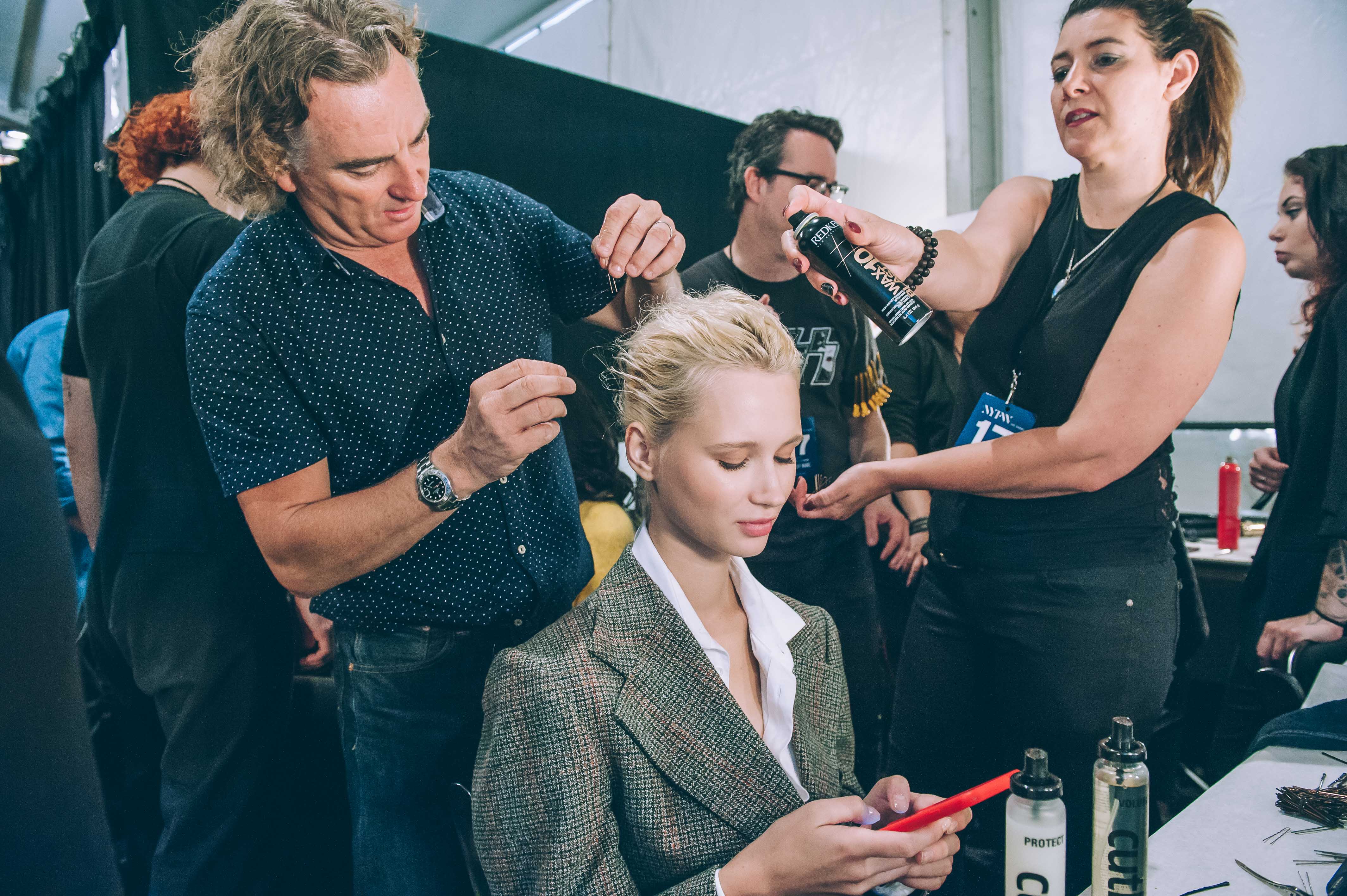 Image of Rodney Cutler styling model's hair backstage for Toaray Wang show during New York Fashion Week
